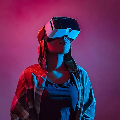 A woman wearing a virtual reality headset, symbolizing women's vital role in innovation and technology development.